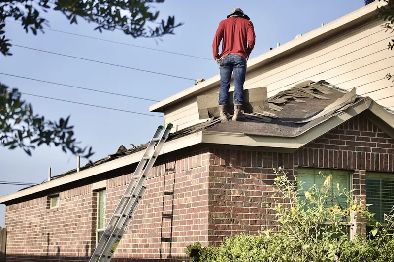 Professional roofer working on a residential roof in Little Chute